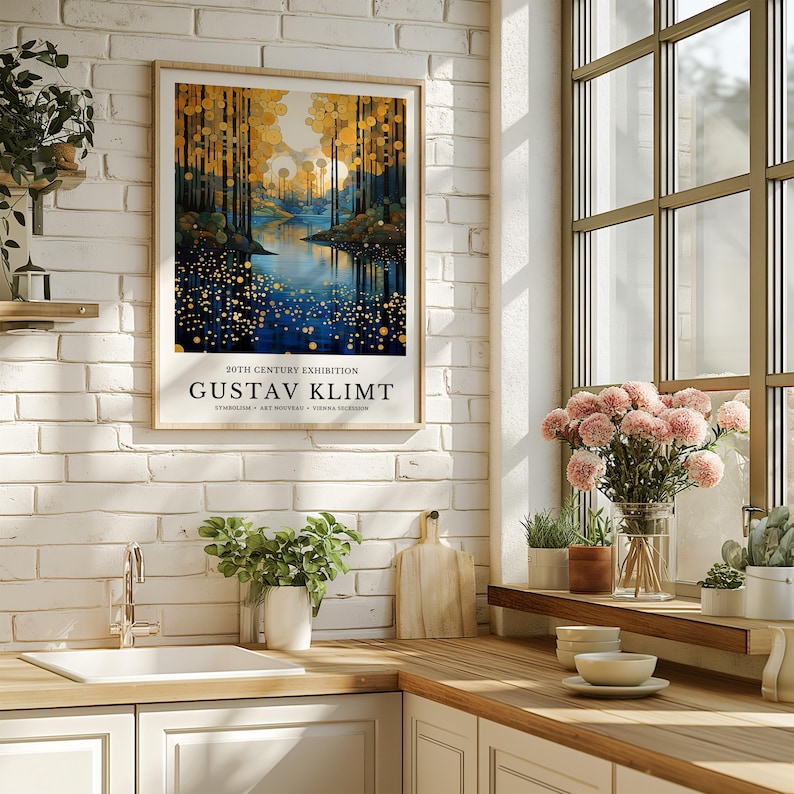 May include: Framed art print featuring a landscape painting with a river and trees in shades of blue, gold, and green. The print includes the text "20TH CENTURY EXHIBITION GUSTAV KLIMT". The artwork is displayed in a kitchen setting.