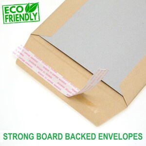 May include: A brown cardboard envelope with a gray cardboard insert. The envelope has a peel-and-seal closure with a white adhesive strip. The envelope is labeled "ECO FRIENDLY" and "STRONG BOARD BACKED ENVELOPES".