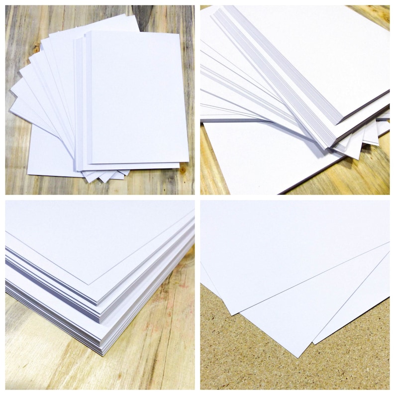 May include: Four stacks of white paper, each stack is arranged differently. The paper is smooth and has a slight sheen. The paper is on a wooden surface.
