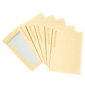 May include: A stack of six light brown envelopes with the text "Please do not bend" printed on each envelope.