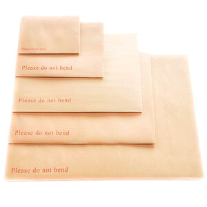 May include: Five brown paper envelopes of different sizes stacked on top of each other. Each envelope has the text "Please do not bend" printed in red.
