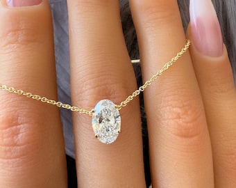 May include: A gold chain necklace with a large oval-shaped diamond pendant.