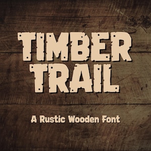 May include: The text TIMBER TRAIL and A Rustic Wooden Font are displayed in a light beige, blocky, distressed typeface with small circular accents, set against a dark brown, horizontal wood grain background with visible planks and texture.