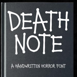 May include: A black book cover featuring the white text DEATH NOTE in a stylised, handwritten font at the top, with the smaller white text A HANDWRITTEN HORROR FONT positioned directly below it, all set against a dark, textured background.