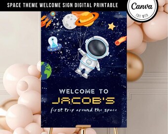 May include: A blue and black welcome sign with a cartoon astronaut holding balloons with planets. The sign says "Welcome to Jacob's first trip around the space".