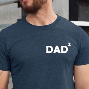 May include: A dark blue t-shirt with the text "DAD²" printed in white on the front.