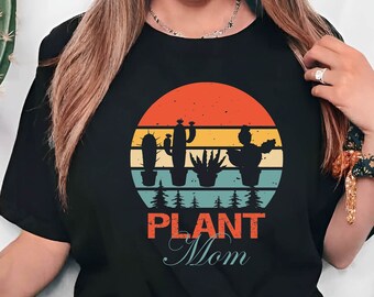 May include: A black t-shirt with a retro sunset graphic and the text "Plant Mom".