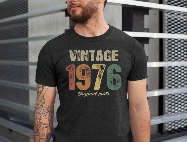 May include: A dark grey t-shirt with a vintage-style graphic that says "Vintage 1976 Original Parts".