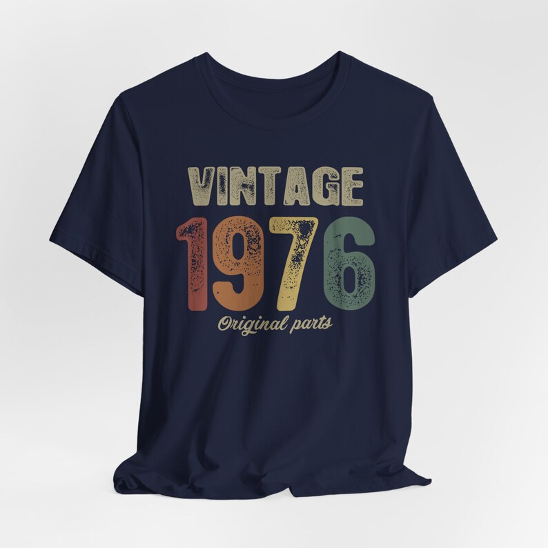 May include: Navy blue t-shirt with a vintage-style graphic that says "Vintage 1976 Original parts".