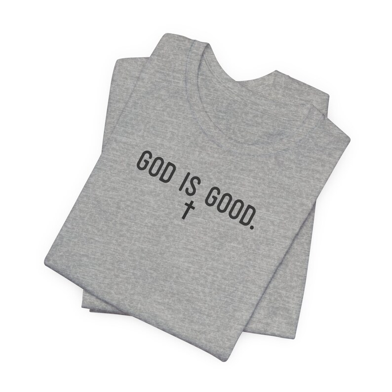 May include: A gray t-shirt with the text "GOD IS GOOD." and a cross symbol.