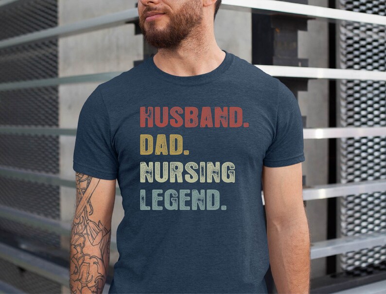 May include: A navy blue t-shirt with the text "Husband. Dad. Nursing Legend." in a vintage style font.