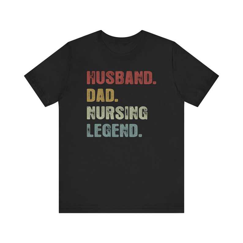 May include: Black t-shirt with a vintage-style graphic that reads "Husband. Dad. Nursing Legend."