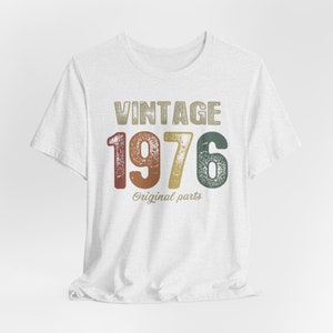 May include: White t-shirt with a vintage-style graphic that says "Vintage 1976 Original parts".