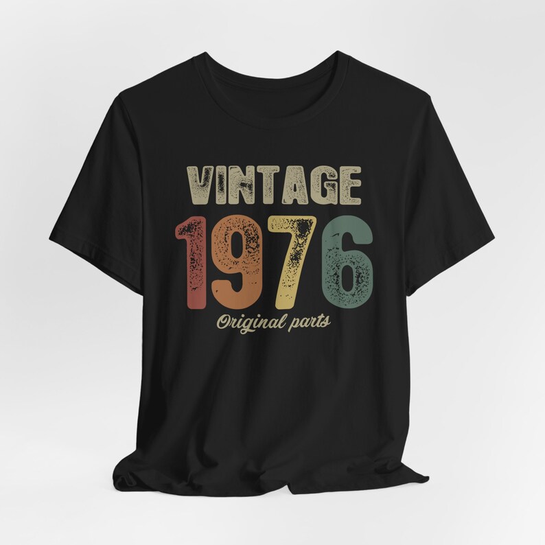 May include: Black t-shirt with a vintage-style graphic that says "Vintage 1976 Original Parts".