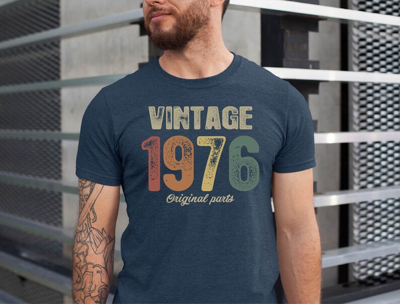 May include: A navy blue t-shirt with a vintage-style graphic that says "Vintage 1976 Original Parts".
