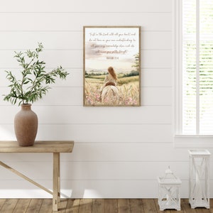 May include: A framed watercolor print depicts a person riding a white horse through a field of wildflowers. The artwork features a landscape with a sunset and text that reads "Trust in the Lord with all your heart... Proverbs 3:5-6."
