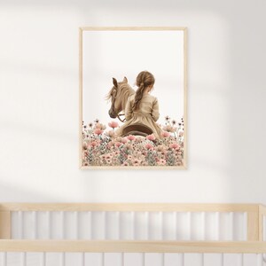 May include: A framed illustration of a girl riding a horse through a field of pink flowers. The girl is wearing a long dress and has her hair pulled back. The horse is brown and white.