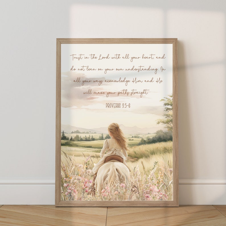 May include: A framed print featuring a watercolor illustration of a girl riding a white horse through a field of wildflowers. The artwork includes the text "Trust in the Lord with all your heart, and do not lean on your own understanding. Proverbs 3:5-6."