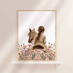 May include: A girl in a long dress rides a brown horse through a field of pink flowers.