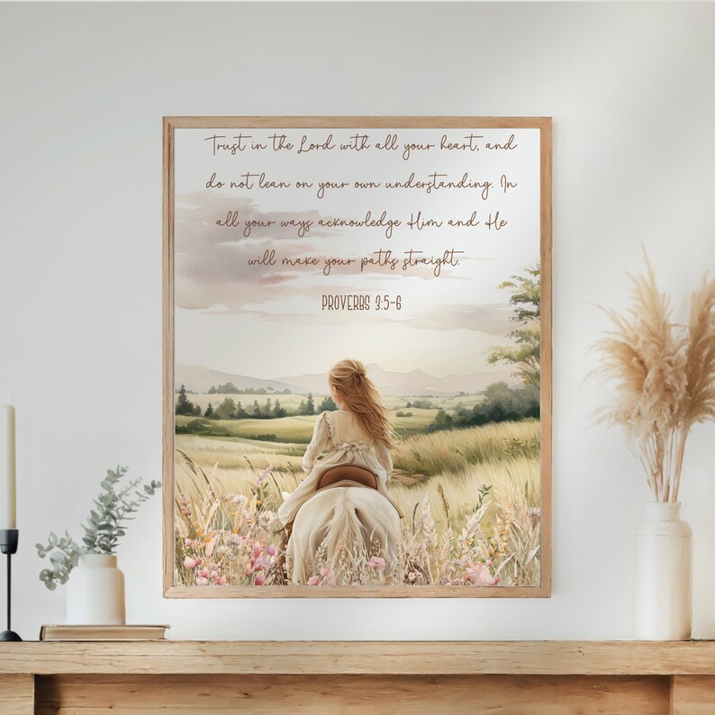 May include: A framed watercolor print featuring a girl riding a white horse through a field of wildflowers. The artwork includes the text "Trust in the Lord with all your heart" and "Proverbs 3:5-6". The color palette is soft, with pastel tones.