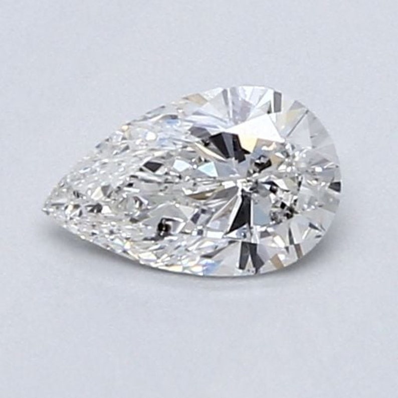 May include: A pear-shaped diamond with a brilliant cut and many facets. The diamond is clear and colourless.