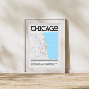 May include: A white framed poster with a map of Chicago and the text "CHICAGO" in black. The map shows the route of the Chicago Marathon, which is 26.2 miles or 42.195 km. The text below the map reads "CHICAGO MARATHON" and describes the race.
