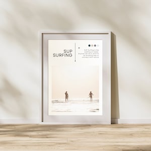 Könnte beinhalten: Ein gerahmtes Poster mit einem Zitat über Stand Up Paddling. Das Poster zeigt ein Foto von zwei Personen, die im Meer paddeln. Das Zitat lautet "SUP Surfing is like walking on water. Anyone can do it, and it's an amazing way to connect with nature."