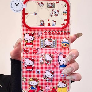 May include: Clear phone case featuring a red and white gingham pattern with various Hello Kitty character stickers. The case has a red border and includes stickers of Hello Kitty with bows, hearts, and other themed graphics. The text "HELLO" is visible.