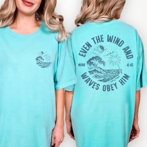 Comfort Colors 1717 Seafoam t-shirt featuring a circular back design with ocean waves, palm tree, and Mark 4:41 Bible verse 'Even the wind and waves obey him'. Christian beach apparel for men and women.