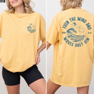 Experience the serene power of faith with our Comfort Colors shirt, inspired by the scripture from Mark 4:41. This waves obey him shirt beautifully captures a moment of divine calm, perfect for those who cherish ocean inspired style and seek a meaningful church service shirt. Crafted for comfort and spiritual connection, it’s an ideal choice for beach Christian gatherings or everyday wear.