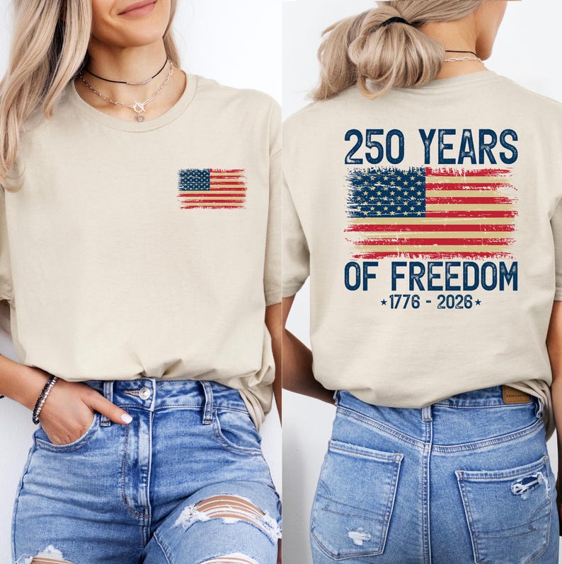 A woman wearing a beige t-shirt with an American flag design and text printed on the back.