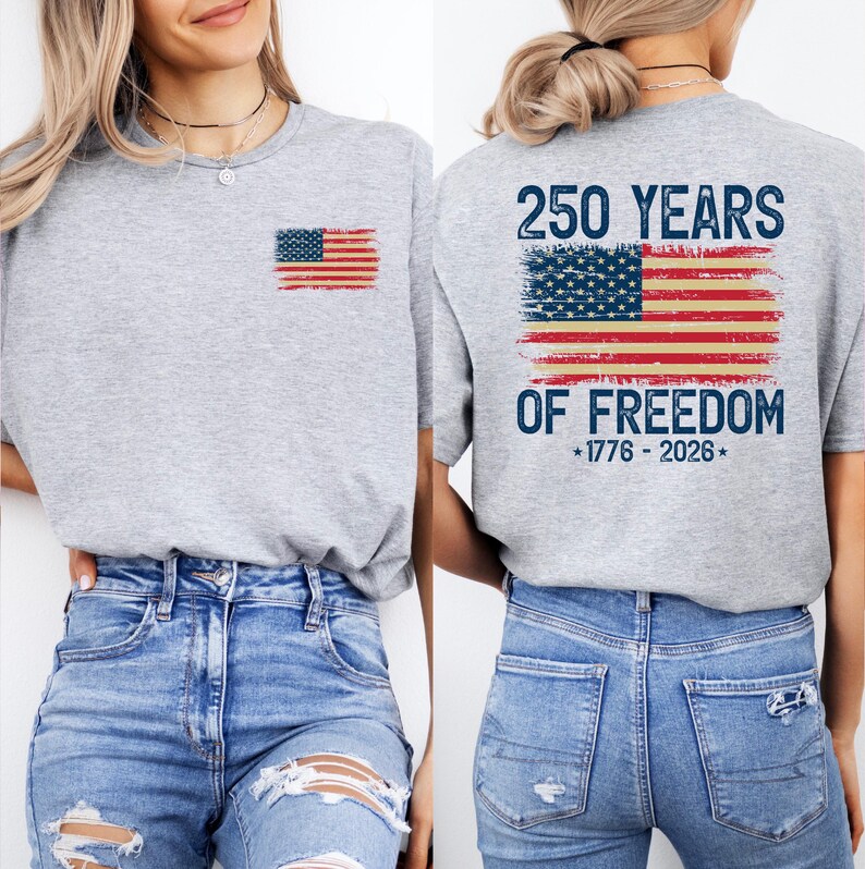 A woman wearing a grey t-shirt with an American flag design and text on the back.