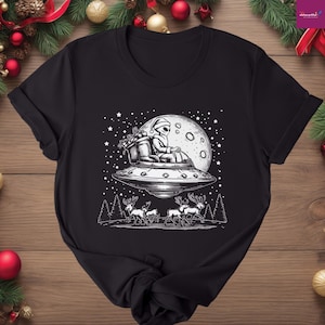 Christmas UFO Tee with Santa Claus Alien, Funny Woodland Santa Riding UFO Tee, Vintage Christmas Alien Gift, Xmas Holiday UFO Graphic Shirt