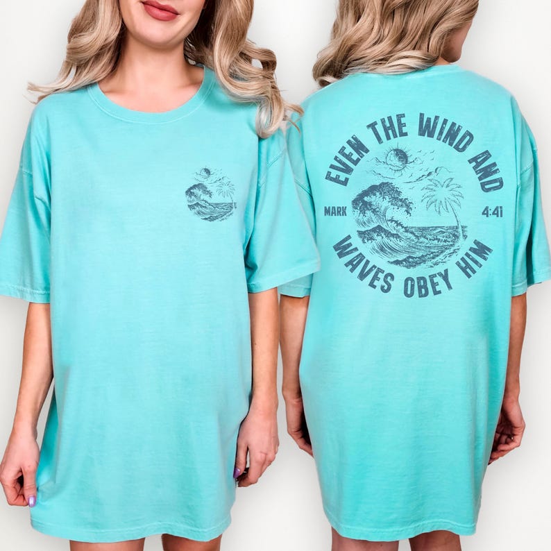 Comfort Colors 1717 Seafoam t-shirt featuring a circular back design with ocean waves, palm tree, and Mark 4:41 Bible verse 'Even the wind and waves obey him'. Christian beach apparel for men and women.