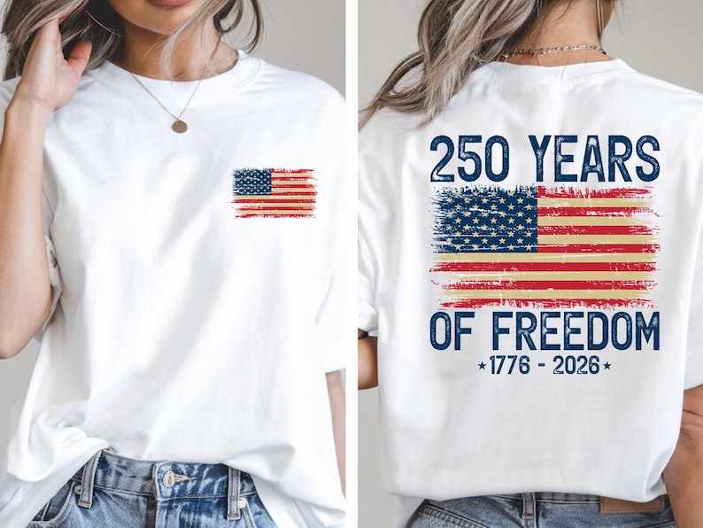 A white t-shirt with a graphic design on the back, depicting an American flag with the text "250 YEARS OF FREEDOM" and "1776 - 2026" printed on it.