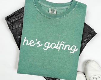 Comfort Colors He's Golfing Shirt, Golf Season TShirt, Golfer Wife Mom Tee, Golf Player T-Shirt
