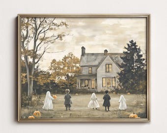 May include: A framed wall art print depicting a two-story house with glowing windows at dusk. In the foreground, four figures stand on a lawn, two dressed as ghosts in white sheets and two in dark clothing, surrounded by scattered orange pumpkins.