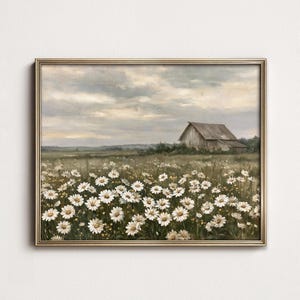 May include: A framed landscape painting featuring a field of white daisies in the foreground under a cloudy sky. In the distance, a weathered wooden barn sits amidst the grassy meadow. The artwork is enclosed in a thin, metallic gold frame.