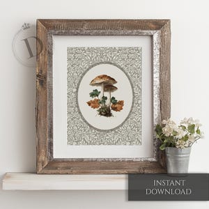 May include: A framed botanical print featuring a detailed illustration of two mushrooms with brown caps and green and orange leaves. The print is set against a gray floral patterned background and framed in rustic wood. The text "INSTANT DOWNLOAD" is at the bottom.