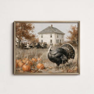 May include: A framed wall art print depicting a large turkey standing in a field of orange pumpkins. In the background, a group of people sits at a long table outside a white two-story house surrounded by trees with autumn-colored foliage.