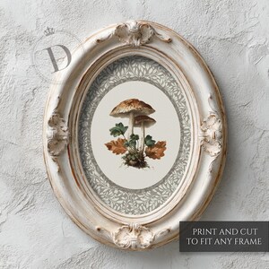 May include: An oval, distressed white picture frame with a botanical print featuring two mushrooms, green leaves, and brown leaves. The print is surrounded by a gray and white floral pattern. The text "PRINT AND CUT TO FIT ANY FRAME" is at the bottom.