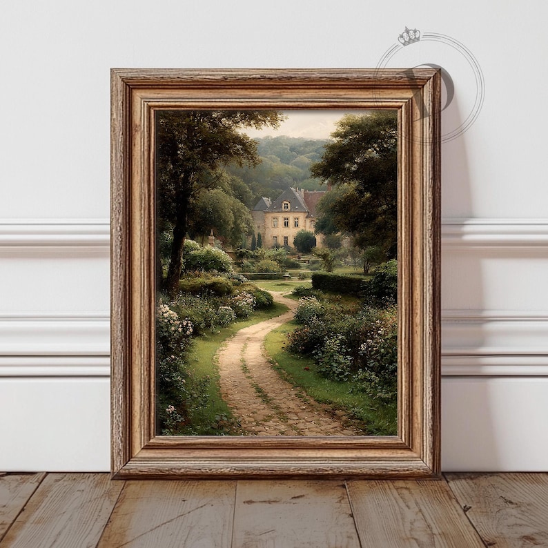 May include: A framed landscape print depicts a winding stone path leading to a large house nestled among lush greenery. The artwork features a warm color palette with shades of green, brown, and beige, evoking a sense of tranquility and natural beauty.