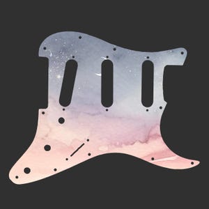 May include: A guitar pickguard with a watercolor design. The pickguard features a gradient of colors, including pink, blue, and white, resembling a sunset or galaxy. It has three elongated holes and several smaller screw holes.