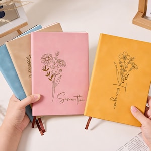 Könnte beinhalten: Ein Set aus drei Keramikbechern mit gesprenkelter, matter Oberfläche. Die Becher sind in Creme-, Hellgrau- und Dunkelgrautönen gehalten. Jeder Becher hat ein schlichtes, minimalistisches Design und einen abgerundeten Henkel.