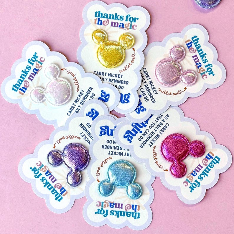 a set of small colorful thank you cards arranged in a circle that say thanks for the magic, and feature a shimmery colorful Mickey Mouse patch in the center