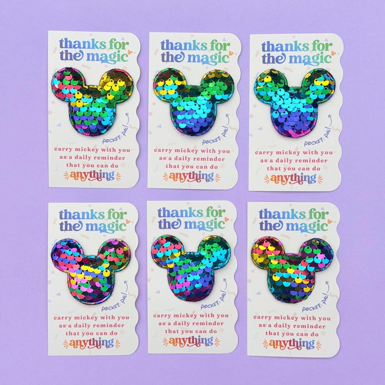 Six white cards featuring rainbow sequin Mickey mouse shapes are arranged in two rows against a purple background.