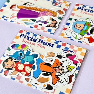 May include: Several packs of stickers featuring Disney characters. One pack has a princess with long blonde hair and a purple dress. Another pack has Buzz Lightyear. The third pack has Stitch, Lilo, and Goofy. The packs are labeled "Pixie Dust Sticker Pack."