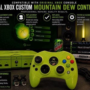 May include: A lime green custom Xbox controller featuring a central Xbox logo with Mountain Dew branding, black thumbsticks, and coloured action buttons. The controller is displayed alongside a matching green console, a black power cord, and two spare thumbsticks.