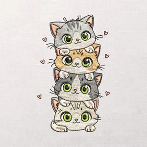 May include: Embroidered design featuring a stack of four cartoon cats. The cats are in shades of gray, orange, and white, each with large green eyes and small pink hearts scattered around them. The design is on a white background.