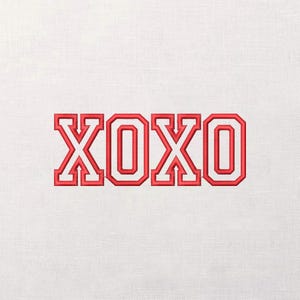May include: Red embroidered letters XOXO on a white fabric background. The letters have a bold, outlined design, creating a 3D effect. The fabric has a subtle, textured appearance.